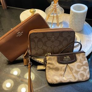 Coach bundle for sale. One leather wallet and two fabric wristlets. No rips/tear